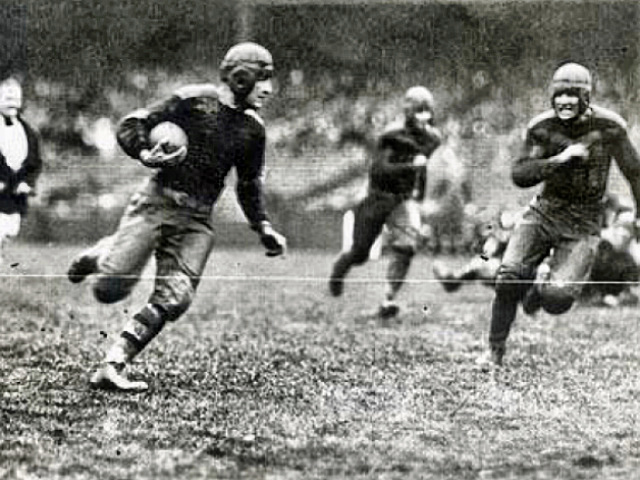 Red Grange running with ball