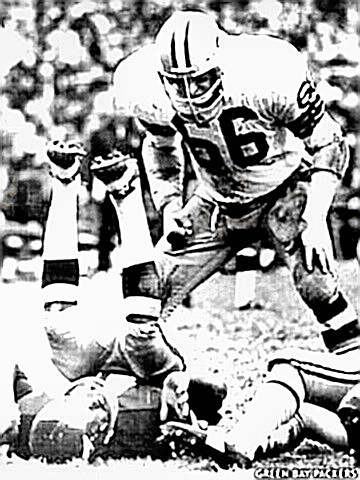 Ray Nitschke stands over decleated ball carrier